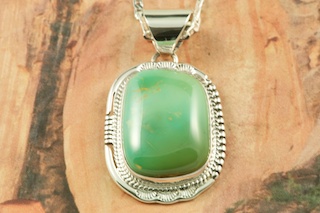 Genuine Manassa Turquoise set in Sterling Silver Pendant. This Turquoise is also referred to as King�s Manassa Turquoise. The Manassa Turquoise mine is located in Manassa, Conejos County, Colorado. Created by Navajo Artist John Nelson. Signed by the artist. Free 18